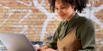 fiber internet for business, small business internet tips, image of woman on laptop