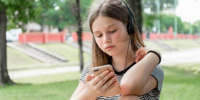 childs first phone, teen on phone, what age to get a phone