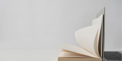 internet archive, wayback machine, image of book laying on laptop