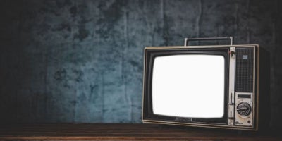 when was tv invented, who invented tv, image of box tv in dark room