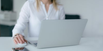 Woman using a mobile hotspot to get internet on her laptop