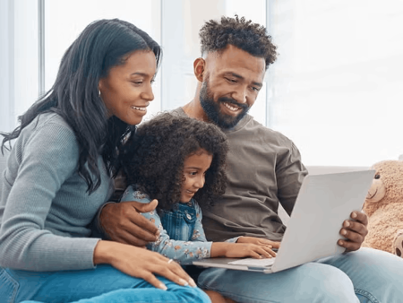 Family looking at laptop screen
