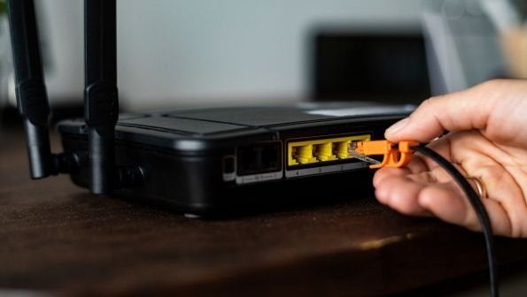 maxxsouth blog, office router reboot, man plugging cord into router