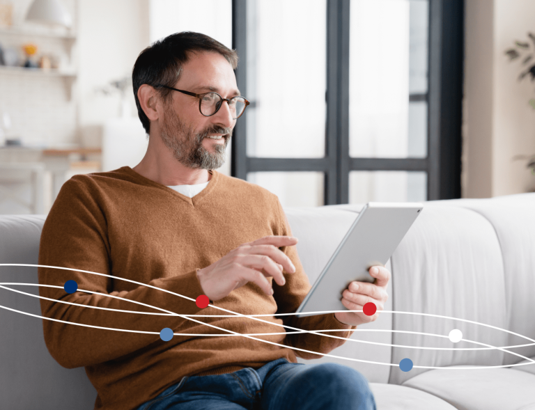 Man on couch using tablet