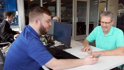 MaxxSouth employee providing customer service at retail internet store in Oxford, MS